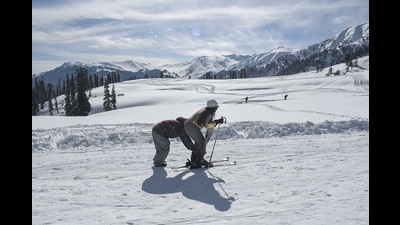 A skier being assisted to ski on the snow-covered slopes at Kangdori ski resort, Gulmarg, in Baramulla on Thursday. A day after two skiers from Poland were killed when an avalanche hit a group of skiers, skiing resumed in Gulmarg on Thursday. (ANI)