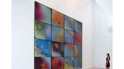 Sightings, 2017: This suite of lenticular prints resembles telescopic snapshots of distant cosmic phenomena, but they’re really close-up views of the surfaces of fruit. Each print integrates images of the fruit as our eyes perceive it, with its chromatic opposite — an image made up of the colors that the fruit surface absorbs and which are invisible to the human eye. As a viewer changes their position with respect to the photo-piece, these images begin to, in a sense, reveal their opposites, and one can discern the peel of an orange or a peach. (Courtesy: Jitish Kallat)