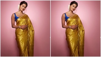 Pooja decked up in a yellow saree and teamed it with a contrasting blue sleeveless blouse, and accessorised her look in golden jewellery. (Instagram/@hegdepooja) Pooja decked up in a yellow saree and teamed it with a contrasting blue sleeveless blouse, and accessorised her look in golden jewellery. (Instagram/@hegdepooja)
