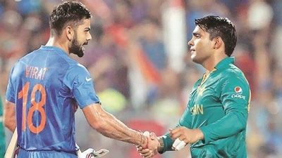 Virat Kohli (L) with Umar Akmal (AP) Virat Kohli (L) with Umar Akmal (AP)
