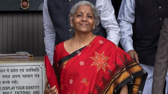 Finance minister Nirmala Sitharaman, who is a Rajya Sabha member from Karnataka, wore Dharwad region's hand-woven 'Ilkal' silk saree with traditional 'Kasuti' work.(REUTERS)