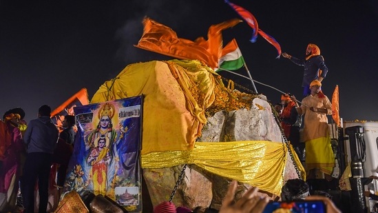 Volunteers and devotees holding Indian and Nepal's flags place the Shaligram stone, coming from Nepal, at Ramsevak Puram in Ayodhya, Wednesday.(PTI)
