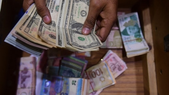 A dealer counts US dollars at a money exchange market in Karachi. (File)