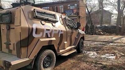 A central reserve police force (CRPF) van seen outside one of the locations where the state investigation agency (SIA) conducted a raid in Srinagar on Friday. (ANI)