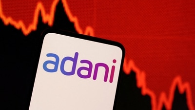Adani logo and decreasing stock graph is seen in this illustration. (REUTERS)
