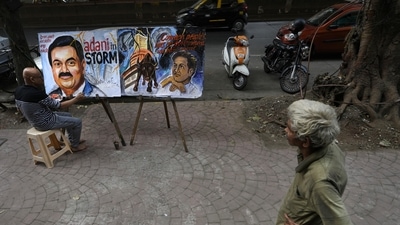 An artist Sagar Kambli paints Indian businessman Gautam Adani, depicting the ongoing Adani group- hidenburg research row. (AP) An artist Sagar Kambli paints Indian businessman Gautam Adani, depicting the ongoing Adani group- hidenburg research row. (AP)