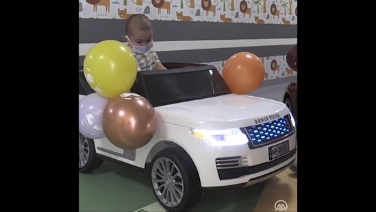 The kid battling cancer is going to the treatment area in the mini car at a hospital in Turkey. (Twitter/@anadoluagency)
