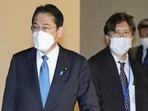 Senior aide to the prime minister Masayoshi Arai, right, walks next to Prime Minister Fumio Kishida