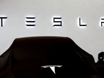 Tesla car covered by black cloth.