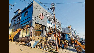 An illegal structure being demolished during state government’s ongoing anti-encroachment drive, at Malik Market area, in Jammu on Saturday. (ANI)