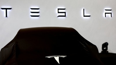 Tesla car covered by black cloth. (REUTERS)