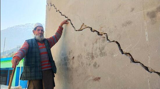 A resident shows the cracks developed on the wall of a house as Doda experiences gradual sinking, on Saturday. (ANI) A resident shows the cracks developed on the wall of a house as Doda experiences gradual sinking, on Saturday. (ANI)