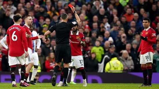 Referee Andre Marriner shows a red card to Manchester United's Casemiro, right, during the English Premier League soccer match between Manchester United and Crystal Palace, at the Old Trafford stadium in Manchester, England, Saturday, Feb. 4, 2023. (AP)