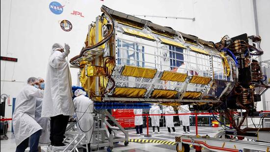 Clean room engineers and technicians prepare the scientific core of the NASA-ISRO Synthetic Aperture Radar (NISAR) satellite inside a Spacecraft Assembly Facility clean room at NASA's Jet Propulsion Laboratory in Pasadena, California. (Getty Images via AFP)