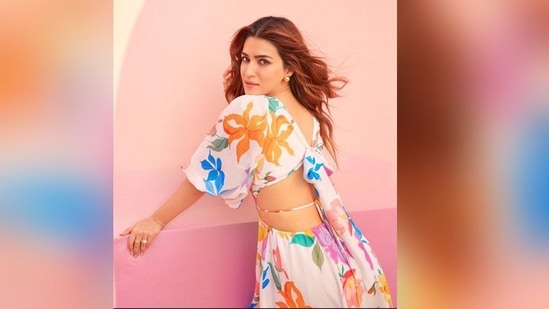Striking sultry poses for the camera in the radiant floral dress, Kriti flaunted the sexy back of her dress featuring a bow and a backless detail tied together with a dori which added the oomph factor to her dress.&nbsp;(Instagram/@Kritisanon)