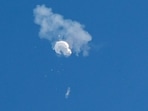 The suspected Chinese spy balloon drifts to the ocean after being shot down off the coast in Surfside Beach, South Carolina.