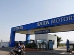 Men ride a motorbike past a Tata Motors car plant at Sanand, in Gujarat.