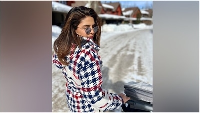 Priyanka's ensemble comes in a white hue decorated with a blue and red check-print pattern. It featured a hoodie on the back, a figure-hugging silhouette, side pockets, puffed shoulders, full-length sleeves, and cinched cuffs and hems. (Instagram) Priyanka's ensemble comes in a white hue decorated with a blue and red check-print pattern. It featured a hoodie on the back, a figure-hugging silhouette, side pockets, puffed shoulders, full-length sleeves, and cinched cuffs and hems. (Instagram)