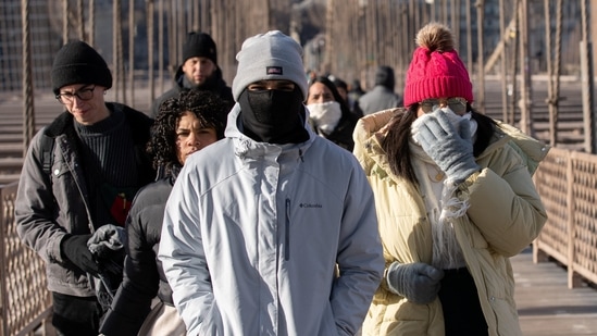 People walk during cold temperature and high winds in Manhattan, as deep cold spread across the northeast United States in New York City, New York, U.S. February 4, 2023. (REUTERS)