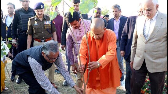 Uttar Pradesh chief minister Yogi Adityanath planting a sapling at the venue of the Global Investors Summit in Lucknow. (HT PHOTO)