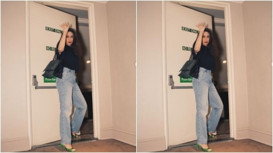 Karisma tucked her oversized black T-shirt into her jeans, and carried a black leather sling bag, as she posed for the cameras.&nbsp;(Instagram/@therealkarismakapoor)