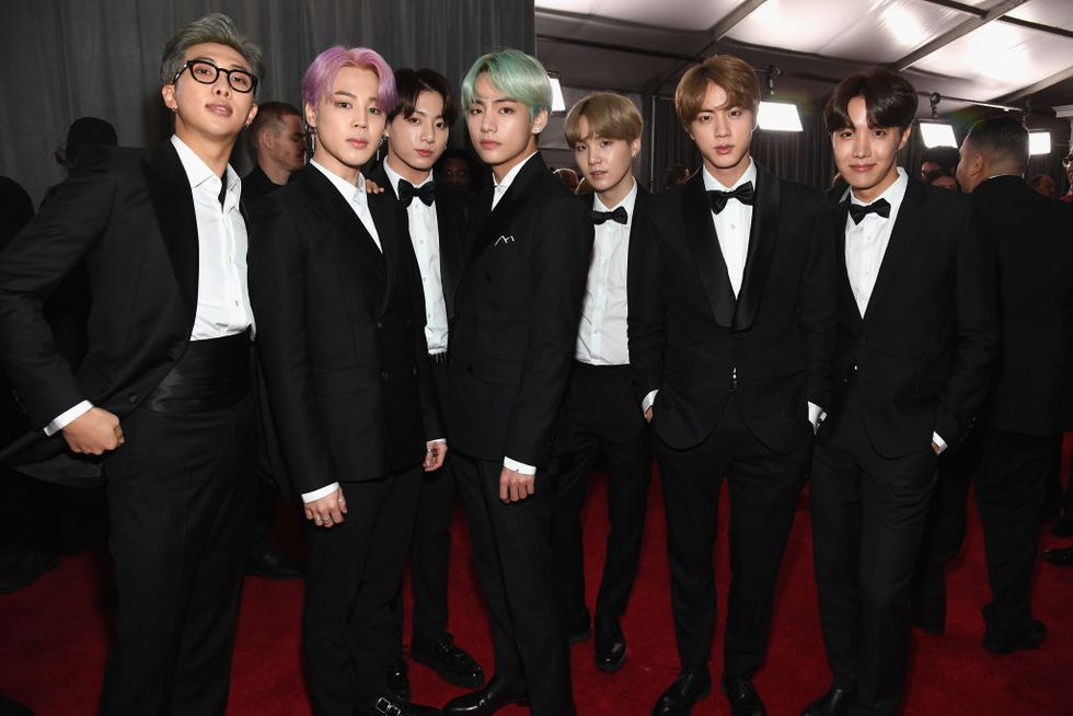BTS turn airport into fashion show ahead of 64th Grammy Awards at