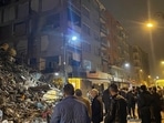 Turkey Earthquake: People gather around a collapsed building in Pazarcik, in Kahramanmaras.(AP) Turkey Earthquake: People gather around a collapsed building in Pazarcik, in Kahramanmaras.(AP)