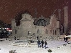 People walk next to a mosque destroyed by the earthquake in Malatya, Turkey.(AP) People walk next to a mosque destroyed by the earthquake in Malatya, Turkey.(AP)