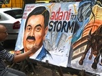 Art school teacher Sagar Kambli gives final touches to a painting of Indian businessman Gautam Adani highlighting the ongoing crisis of the Adani Group in Mumbai.(AFP) Art school teacher Sagar Kambli gives final touches to a painting of Indian businessman Gautam Adani highlighting the ongoing crisis of the Adani Group in Mumbai.(AFP)