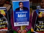 Members of Congress party demand an investigation into allegations of fraud by Adani Group at a protest in New Delhi on Monday (AP) Members of Congress party demand an investigation into allegations of fraud by Adani Group at a protest in New Delhi on Monday (AP)