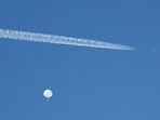 A jet flies by a suspected Chinese spy balloon as it floats off the coast in Surfside Beach, South Carolina, 