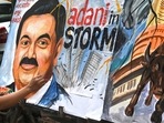 An artist gives final touches to a painting of Gautam Adani highlighting the ongoing crisis of the Adani Group in Mumbai. (File) An artist gives final touches to a painting of Gautam Adani highlighting the ongoing crisis of the Adani Group in Mumbai. (File)