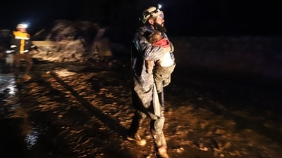 A member of the Syrian civil defense, known as the White Helmets, seen carrying a child rescued from the rubble following an earthquake in the town of Zardana, a northwestern Syrian Idlib province, early on February 6. The earthquake hit while people were asleep, and has resulted in over 1900 deaths. (Abdulaziz Ketaz / AFP) A member of the Syrian civil defense, known as the White Helmets, seen carrying a child rescued from the rubble following an earthquake in the town of Zardana, a northwestern Syrian Idlib province, early on February 6. The earthquake hit while people were asleep, and has resulted in over 1900 deaths. (Abdulaziz Ketaz / AFP)