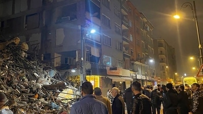 Turkey Earthquake: People gather around a collapsed building in Pazarcik, in Kahramanmaras. (AP) Turkey Earthquake: People gather around a collapsed building in Pazarcik, in Kahramanmaras. (AP)
