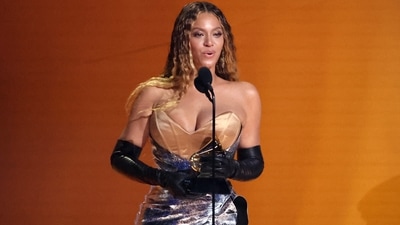 Beyoncé accepts the award for Best Dance/Electronic Music Album for Renaissance in this image, clicked during the 65th Annual Grammy Awards. The singer arrived late for the awards ceremony owing to LA traffic but did not disappoint with her magical look. She chose a gold and silver corset gown styled with Opera gloves, open long hair, and glowing glam.&nbsp; (REUTERS)