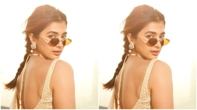 Pooja looked every bit gorgeous in the ivory white sleeveless sequined blouse featuring a plunging neckline and long sleeves with mini frills. She teamed it with a long flowy ivory white skirt and posed for the cameras.&nbsp; (Instagram/@hegdepooja)
