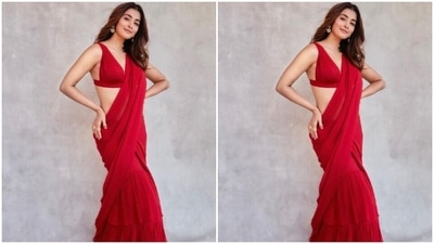 Pooja teamed her saree with a sleeveless matching red blouse and posed for the pictures.&nbsp; (Instagram/@hegdepooja)