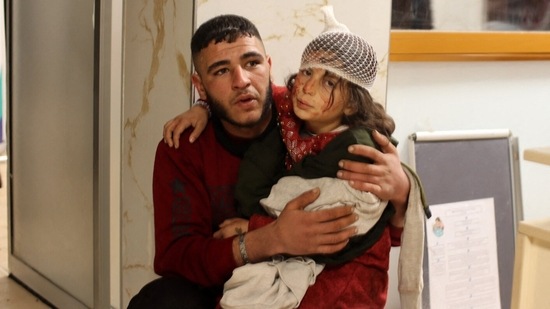 A young injured girl awaits treatment at a hospital following the earthquake, in the border town of Azaz in the rebel-held north of the Aleppo province, on February 6, In the small Syrian rebel-held town of Azmarin, in the mountains by the Turkish border, the bodies of several dead children, wrapped in blankets, were brought to a hospital, AP reported. (Al-Aboud / AFP)