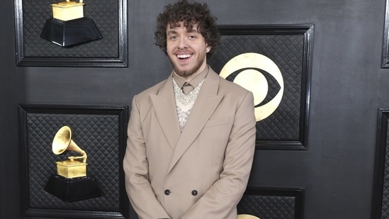 Jack Harlow arrives at the 65th annual Grammy Awards in a sleek grey-coloured double-breasted blazer, straight-fit pants, matching shirt and a printed knit sweater.&nbsp;(Jordan Strauss/Invision/AP)
