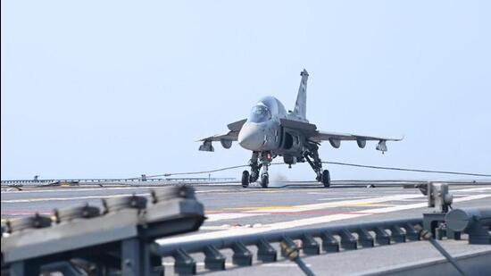 A prototype of the naval version of the locally made light combat aircraft (LCA) on Monday for the first time landed and took off from indigenous aircraft carrier INS Vikrant (HT Photo)