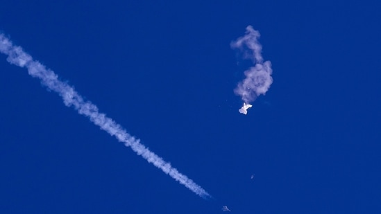 Chinese Spy Balloon: Remnants of a large balloon drift above the Atlantic Ocean, just off the coast of South Carolina, with a fighter jet and its contrail seen.(AP)