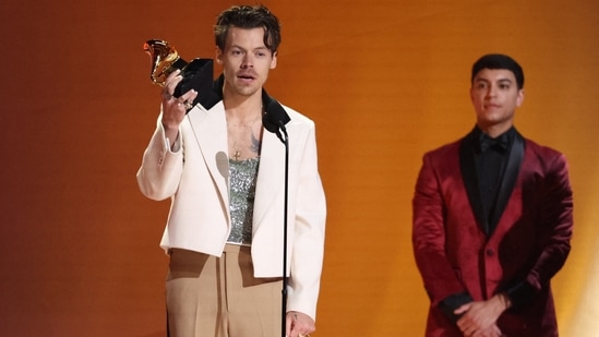 Harry changed into three outfits during the Grammys. Here he accepts the Best Pop Vocal Album award for "Harry's House" dressed in a off-white cropped blazer, tan pants, and a sequinned top.&nbsp;(REUTERS)