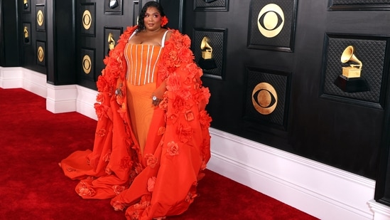 Lizzo stole the show at the 65th Grammy Awards as she arrived in an orange gown and jacket by Dolce and Gabbana. Her ensemble features a corset gown with structured boning, embellished bodice, décolletage-revealing neckline, and a figure-hugging skirt. A larger-than-life jacket and on-fleek glam completed her red-carpet look.&nbsp;(REUTERS)