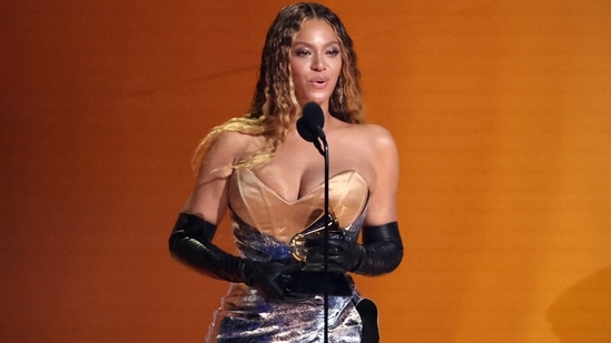 Beyoncé accepts the award for Best Dance/Electronic Music Album for Renaissance in this image, clicked during the 65th Annual Grammy Awards. The singer arrived late for the awards ceremony owing to LA traffic but did not disappoint with her magical look. She chose a gold and silver corset gown styled with Opera gloves, open long hair, and glowing glam.&nbsp;(REUTERS)