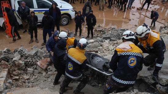 Members of the Syrian civil defence, known as the White Helmets transport a casualty pulled from the rubble following an earthquake in the town of Zardana in the countryside of the northwestern Syrian Idlib province, early on Monday.(AFP)