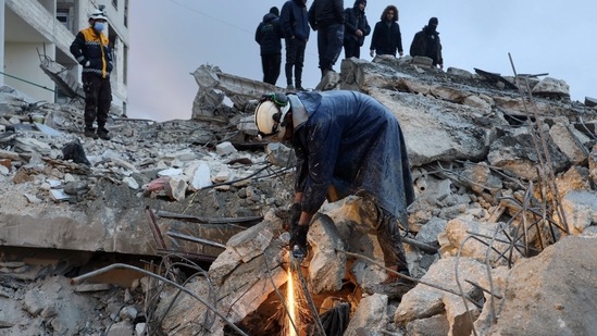 Members of the Syrian civil defence, known as the White Helmets look for casualties under the rubble following an earthquake in the town of Zardana in the countryside of the northwestern Syrian Idlib province, early on February 6, 2023. (AFP)