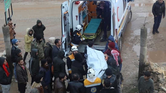 Rescuers carry a casualty into an ambulance at the site of a damaged building in earthquake hit Syria.(REUTERS)