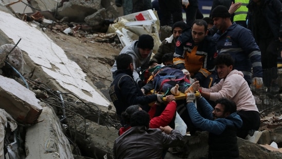 Rescuers carry out a person from a collapsed building after the earthquake.(REUTERS)