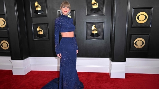 Taylor Swift painted the Grammys in a midnight blue haze as she wore a sparkly navy crop top and skirt by Roberto Cavalli. She accessorized with Lorraine Schwartz jewellery, including dramatic dangle earrings, and for glam, she wore her hair up in a bun and came out in her signature red lipstick.&nbsp;(AFP)