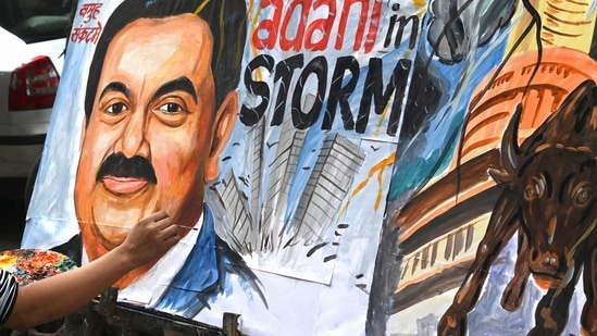 An artist gives final touches to a painting of Gautam Adani highlighting the ongoing crisis of the Adani Group in Mumbai. (File)